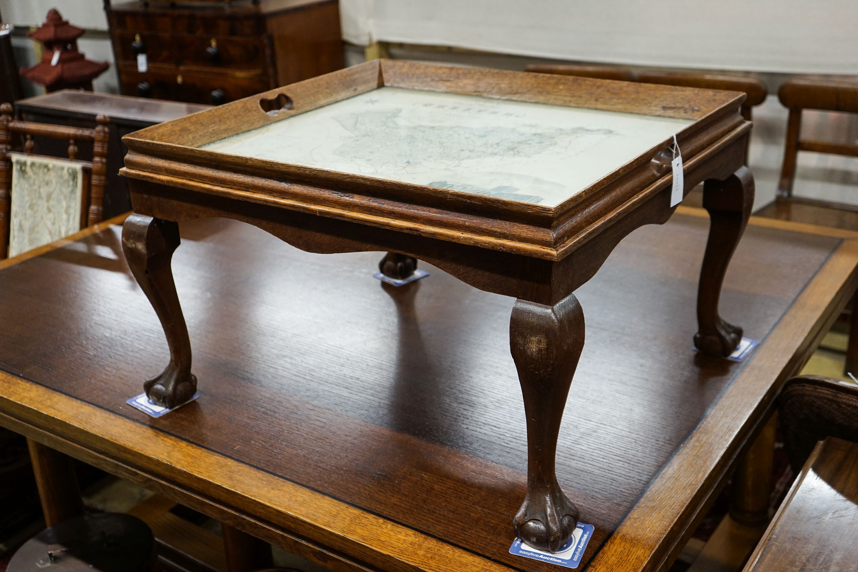 A rectangular oak tray top low table inset with a map of Cheshire on ball and claw stand, width 80cm, depth 70cm, height 48cm